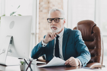 Professional businessman in a formal suit working in a modern office environment with confidence...