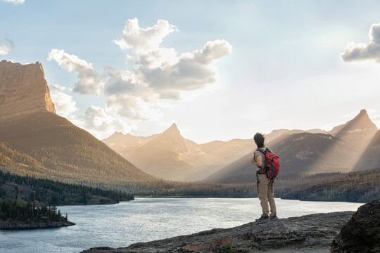 hiker admiring the scenery at Sun Point in Glacier National Park at sunset