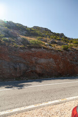 Rocky hillside road in daylight.