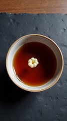 Elegant hot beverage with a delicate flower garnish in a ceramic bowl