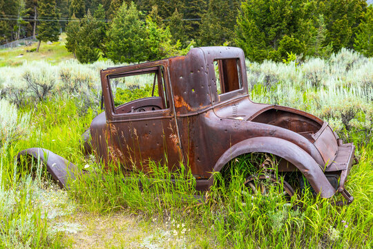 Rusty Vintage Car with Bullet Holes at Elkhorn Ghost Town, Montana - Powered by Adobe