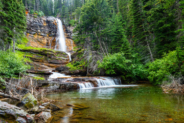 Scenic Virginia waterfall close up in Glacier National Park on summer day