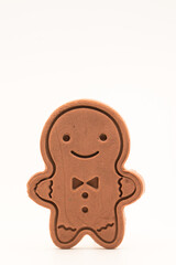 Vertical photograph of a reindeer-shaped gingerbread Christmas cookie on a white background