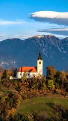 Fototapeta premium Church atop a hill, autumnal landscape