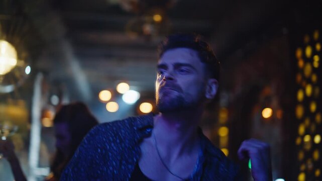 Energetic guy dancing nightclub enjoying disco vibe closeup. Happy man moving