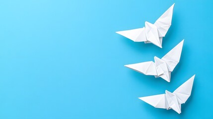 Three White Origami Birds on Blue Background