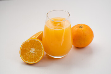 Glass of Fresh Orange Juice with Halved Oranges – Clean Minimal Food Photography