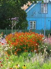 traditional old historic wooden architecture house with flowers in summer in Nida, Curonian spit with a fountain in Lithuania, Europe