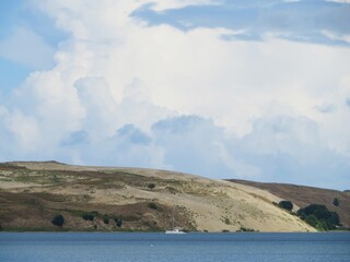 beautiful Dead dunes in Curonian spit, Lithuania, Europe with a curonian lagoon with a white yacht family in summer
