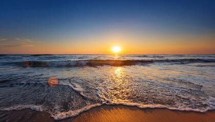 Fototapeta premium sea waves the sun rising in the quiet of the morning beautiful landscape with sunrise at the sea