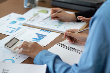 Data Analysis. Team members reviewing financial documents and calculations.