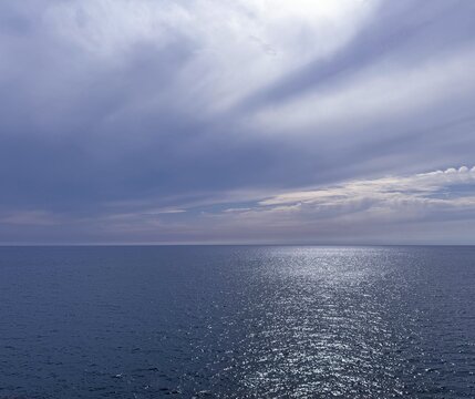 Beautiful glittering sea and cloudy sky.