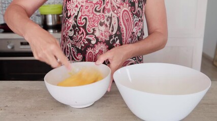 4K close-up video of eggs being whisked in a deep white bowl while making apple cake, homemade baking process, fresh ingredients, healthy food, nutritious dessert, cooking at home, nutrition concept