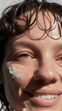 Young Woman with Eyes Closed Gently Applying Face Cream