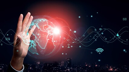 A person engages with a holographic projection of Earth, surrounded by digital elements, symbolizing modern technology and connectivity in a dynamic urban setting. Xenic