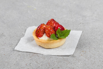 Mini Round Strawberry tartlet. Light gray background. Close up