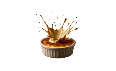 Delicious cr me br l e dessert with a dramatic caramel splash frozen in motion presented elegantly in a ramekin isolated on transparent background