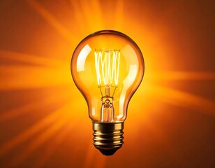 Illuminated lightbulb against a warm orange background