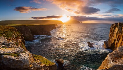 sunset over rocky coastal cliffs