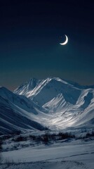 Crescent moon over snow-capped mountains