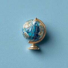 Exquisite miniature blue and gold globe evokes a sense of discovery and global awareness