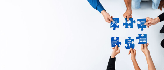 A dynamic image showcasing multiple hands working together to assemble blue puzzle pieces,...