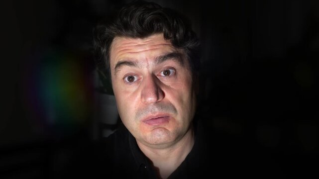 Handsome man expressing surprise emotion. Face close-up. Bright lighting.
