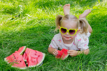 Little girl eating watermelon. Selective focus