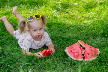 Little girl eating watermelon. Selective focus