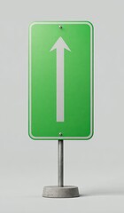 A bright green traffic sign with a white arrow pointing upward, mounted on a gray metal post with a concrete base