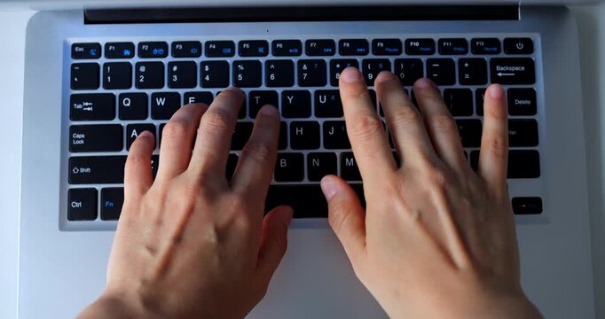 Multiple views of a programmer's hands typing on a laptop keyboard, showcasing different stages of the typing process in a seamless sequence
