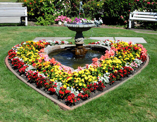 Heart shaped flowerbed with fountain