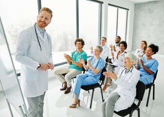 Portrait of a young doctors and nurses in audiance during a seminar in a board room or during an educational class at convention center