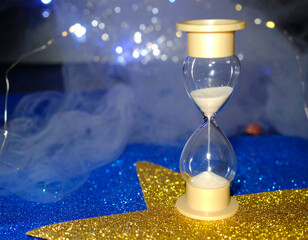 Hourglass on glittery star background