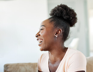 Obraz premium Portrait of a lovely young couple having fun and laughing sharing a donut and eating together at home