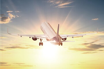 Classic big Airplane flies in blue sunset sky.