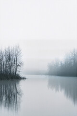 Fototapeta premium Foggy river landscape with trees along the bank 