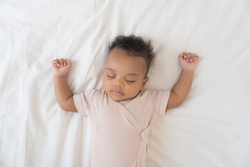 Newborn health care. Top view of newborn baby sleeping on white blanket. African American newborn...