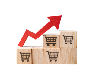 Shopping cart icon on wooden blocks and rising red arrow representing increasing sale
