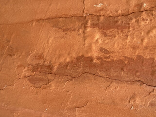 Terracotta surface with weathered cracks and rough texture, natural earthy aged rustic background