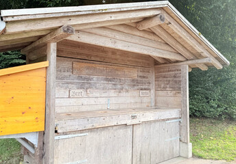 Small wooden hut in countryside, rustic cabin with pitched roof made of logs, traditional rural...