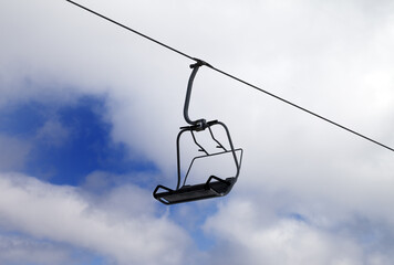 Chair-lift and cloudy sky