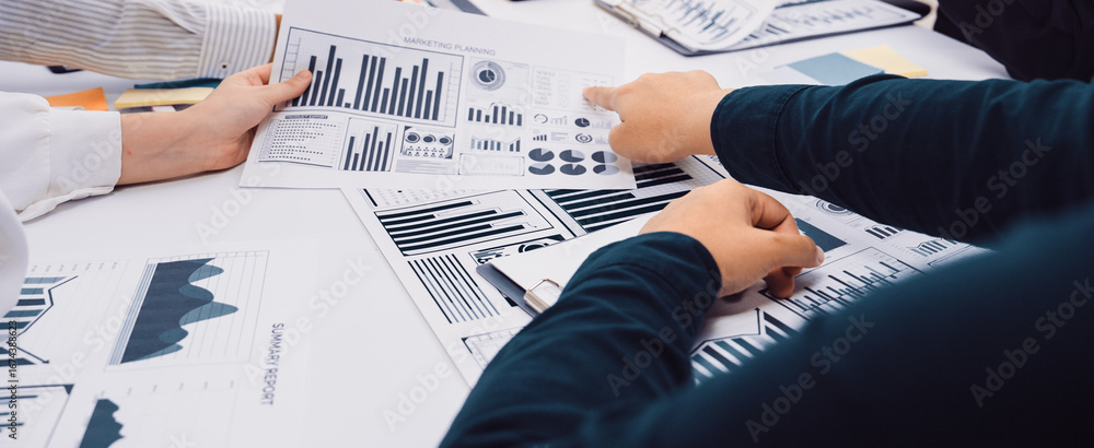 Poster a group of professionals collaborates in a team meeting, analyzing various data charts and graphs to