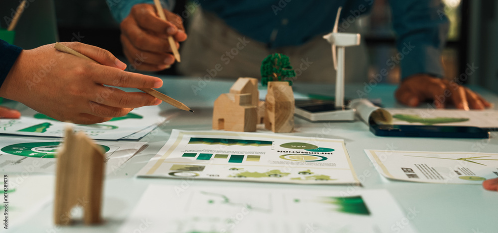 Poster this image captures a collaborative design session where a team focuses on sustainable architecture,