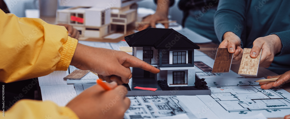 Poster a diverse group of professionals collaborates on an architectural design project using a house model