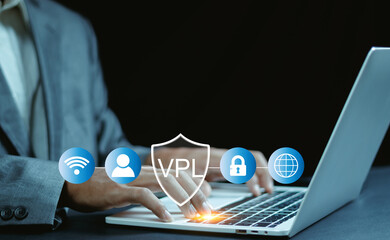 Close-up of hands typing on laptop with virtual VPN shield icon, representing internet security,...