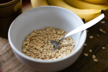 Healthy breakfast bowl with oats and bananas, perfect for a nutritious start to the day during the morning hours © Akshatha