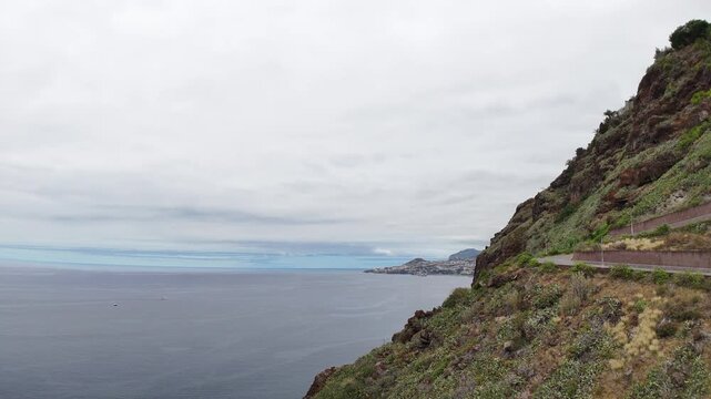 Beautiful view of the mountains and the Christ the Redeemer Statue while flying over the city of Canico - in the south of Madeira Island, Portugal.