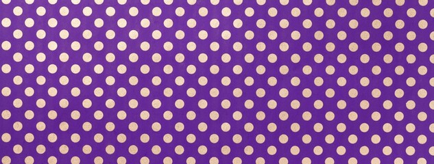 Dark violet background from wrapping paper with white polka dot pattern. Texture of purple dotted paper backdrop