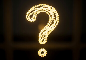 Question mark formed by glowing string lights in darkness